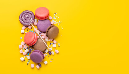 Various colorful candies, lollipops, and macaroons