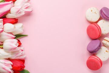 Pastel colorful tulips and vibrant macaroons