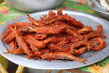 Fried fishes kept on the big plate.
