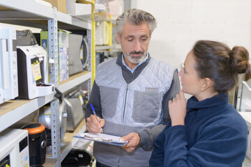 worker and manager scanning package in warehouse