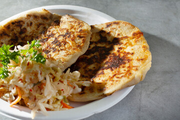 A closeup view of some pupusas on a plate.