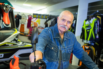 portrait of senior man by jet ski