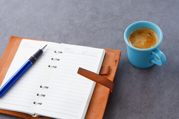 ミルクをたっぷり入れたコーヒー、カフェ・ラッテを飲みながら、日記をつけているイメージ
