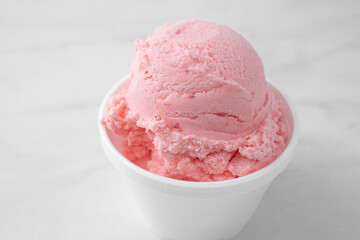 A closeup view of a scoop of strawberry ice cream.