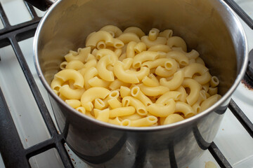 A view of drained macaroni pasta in a stockpot.