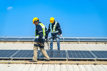 Worker Technicians are working to construct solar panels system on roof with sky and clound on background. Installing solar photovoltaic panel system. Renewable clean energy technology concept.