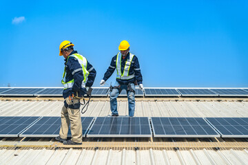 Worker Technicians are working to construct solar panels system on roof with sky and clound on background. Installing solar photovoltaic panel system. Renewable clean energy technology concept.