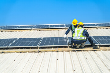 Worker Technicians are working to construct solar panels system on roof with sky and clound on background. Installing solar photovoltaic panel system. Renewable clean energy technology concept.