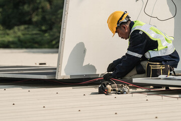 Worker Technicians are working to construct solar panels system on roof. Installing solar photovoltaic panel system. Men technicians carrying photovoltaic solar modules on roof.