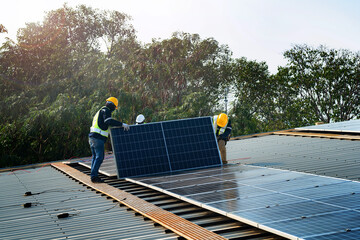 Worker Technicians are working to construct solar panels system on roof. Installing solar photovoltaic panel system. Men technicians carrying photovoltaic solar modules on roof. © ultramansk