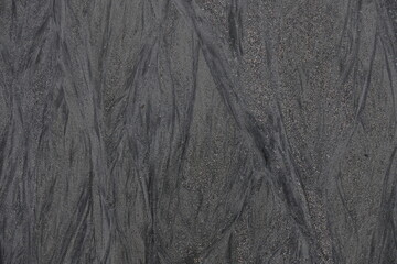 Textured Sand Beach in Wood Pattern. A close-up of a textured sand beach an intricate pattern