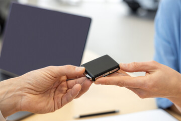 Close up picture of hands with passing the car keys