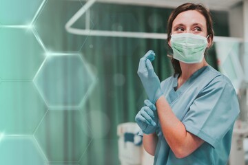 Female nurse with a mask putting on gloves