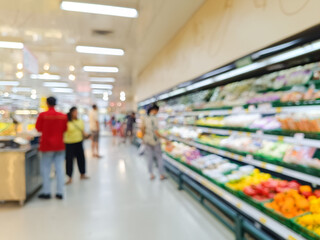 deliberately blurred wide shot of a brightly lit supermarket aisle, focusing on the fresh produce section with a few shoppers in the background, conveying a sense of busy everyday shopping