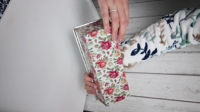 A woman demonstrates a metal shape for baking on the camera. Review of purchases. Vertical video.