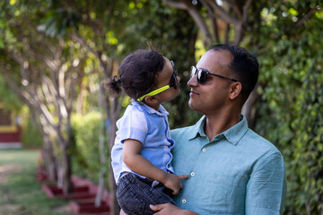 Fototapeta premium indian father and toddler son cozy moments and facial expression at outdoor park at evening