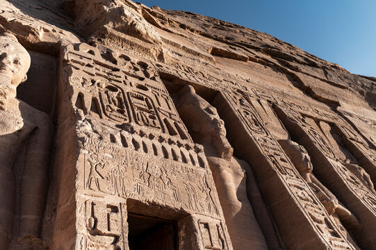 Close-up of hieroglyphics and statues at Abu Simbel temple, ancient Egypt