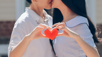 Couples display heart shaped symbols together to show their love and friendship for each other on their big day. making hand shaped heart symbol to express love friendship and kindness towards lovers