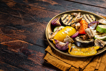 Various grilled Vegetables, bell pepper, zucchini, eggplant, onion and tomato. Wooden background. Top view. Copy space