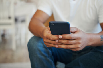 Hands, man and phone on sofa at house for texting, social media post and online chatting by networking app. Person, mobile and research, notification and subscription email for digital entertainment