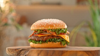 Close-up of home made tasty burgers on old olive wooden table.