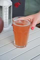 Cold refreshing grapefruit drink sitting on oustide outdoor table