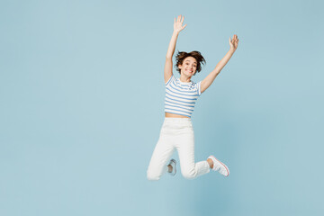 Full body young surprised woman wears striped t-shirt casual clothes jump high raise up hands pov greet somebody isolated on plain pastel light blue cyan background studio portrait. Lifestyle concept.