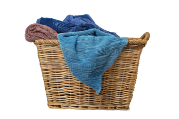 A wicker laundry basket filled with colorful towels, isolated on a white background. Ideal for home, laundry, and cleanliness themes.