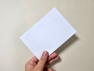 hand holding blank paper, Diagonal Paper Mockup Image