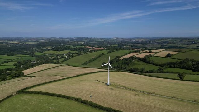 Rattery, near Buckfastleigh, South Devon, England: DRONE VIEWS: A wind turbine surrounded by farm fields. Wind turbines are part of the government renewables strategy for achieving net zero (Clip 1).