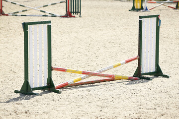  Horse obstacle course outdoors summertime. Poles in the sand for equestrian event