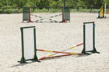  Horse obstacle course outdoors summertime. Poles in the sand for equestrian event