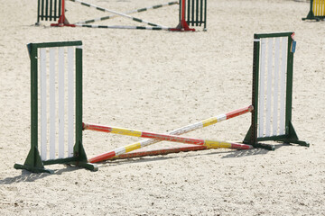  Horse obstacle course outdoors summertime. Poles in the sand for equestrian event