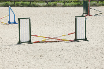  Horse obstacle course outdoors summertime. Poles in the sand for equestrian event