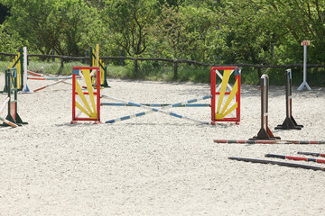  Horse obstacle course outdoors summertime. Poles in the sand for equestrian event