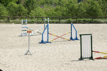  Horse obstacle course outdoors summertime. Poles in the sand for equestrian event