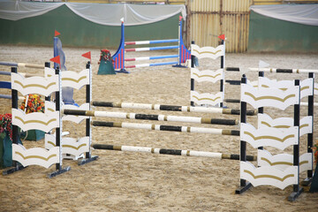  Horse obstacle course outdoors summertime. Poles in the sand for equestrian event