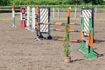  Horse obstacle course outdoors summertime. Poles in the sand for equestrian event