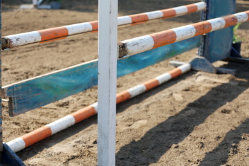  Horse obstacle course outdoors summertime. Poles in the sand for equestrian event