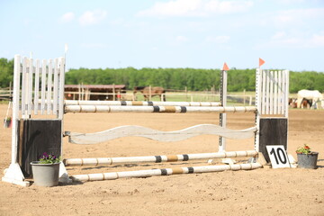  Horse obstacle course outdoors summertime. Poles in the sand for equestrian event
