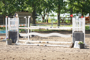  Horse obstacle course outdoors summertime. Poles in the sand for equestrian event