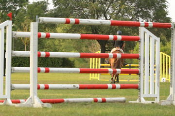  Horse obstacle course outdoors summertime. Poles in the sand for equestrian event