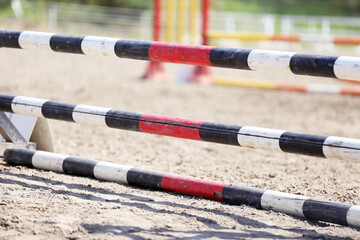  Horse obstacle course outdoors summertime. Poles in the sand for equestrian event