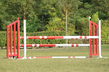  Horse obstacle course outdoors summertime. Poles in the sand for equestrian event