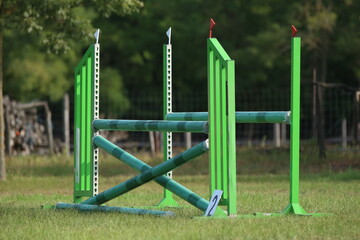  Horse obstacle course outdoors summertime. Poles in the sand for equestrian event