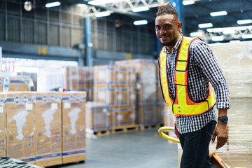 African black male worker in safety vest is working in the warehouse.