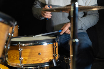 Drummer behind the drums in the studio, at a concert. Professional drum kit in close-up.