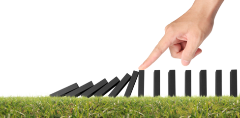 Hand stopping the Domino effect stopped by unique