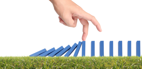 Hand stopping the Domino effect stopped by unique