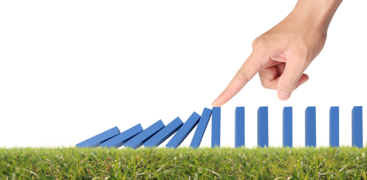 Hand stopping the Domino effect stopped by unique